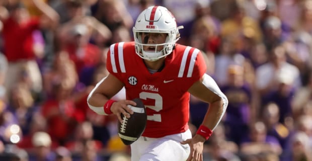 Ole Miss Rebels quarterback Jaxson Dart scrambles on a play during a college football game.